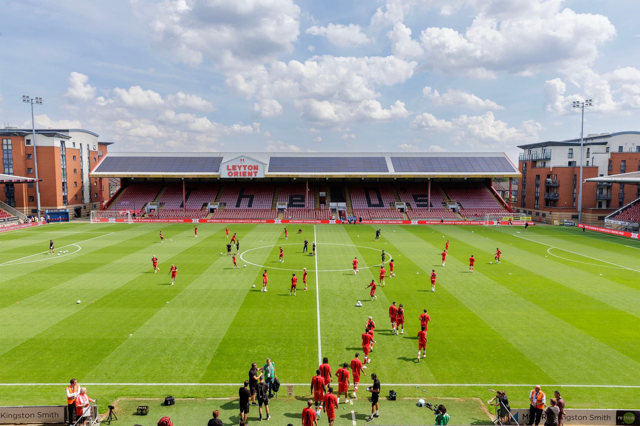 Leyton Orient players warming up in front of the Bullion House Stand
