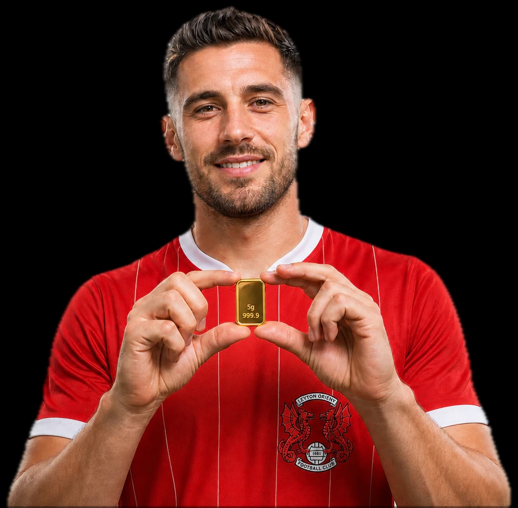 Leyton Orient player holding the 5g gold bar prize
