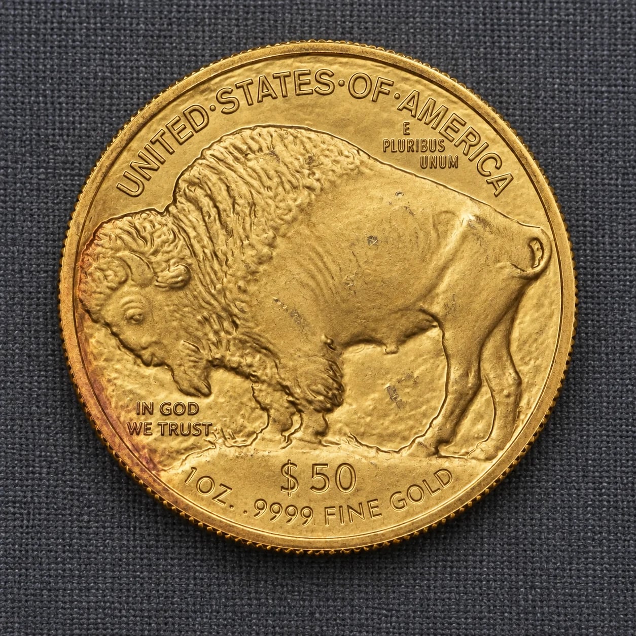 A complete toned 2006 one-ounce American Gold Buffalo coin showing the bison reverse