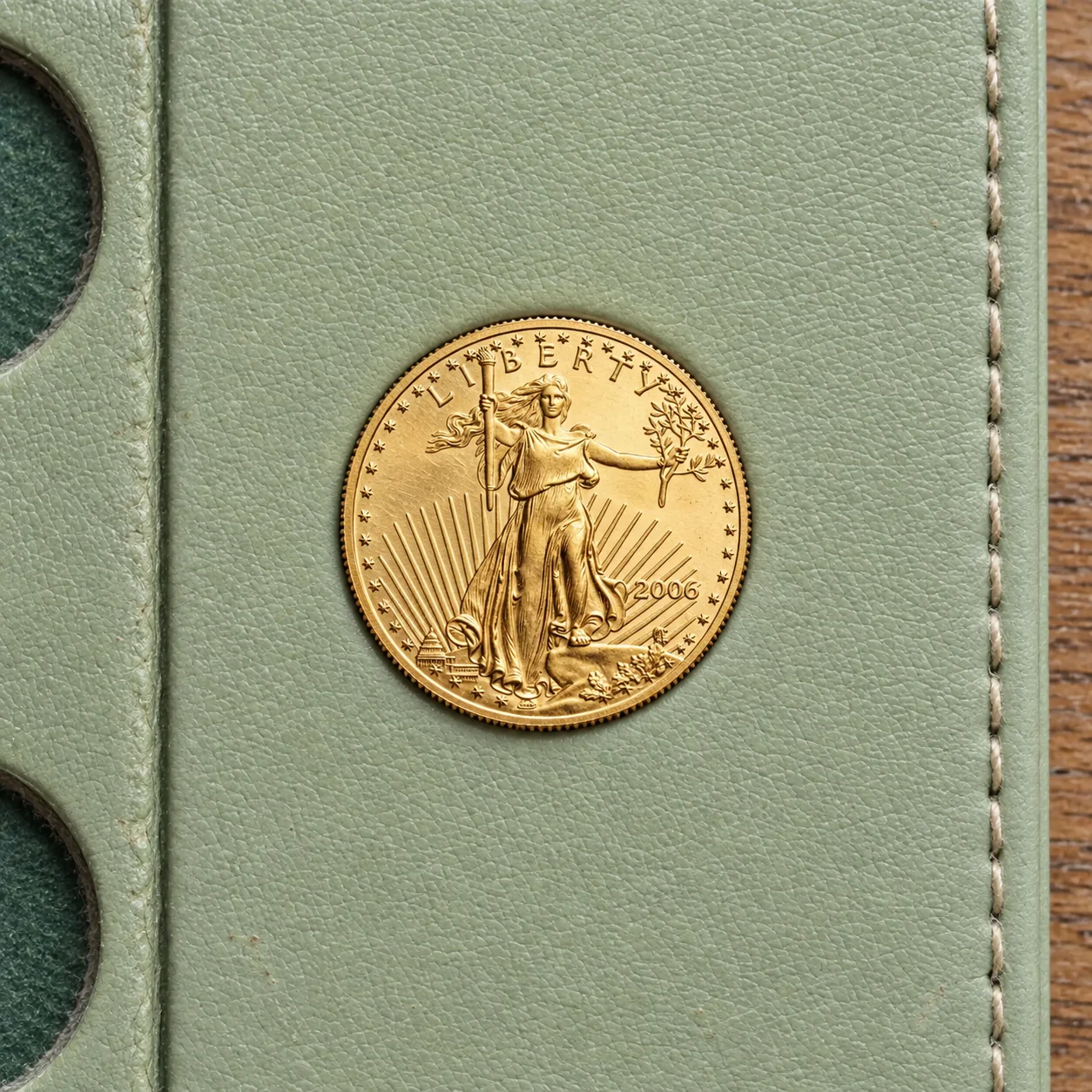 A complete handled 2006 one-tenth-ounce American Gold Eagle coin showing Lady Liberty