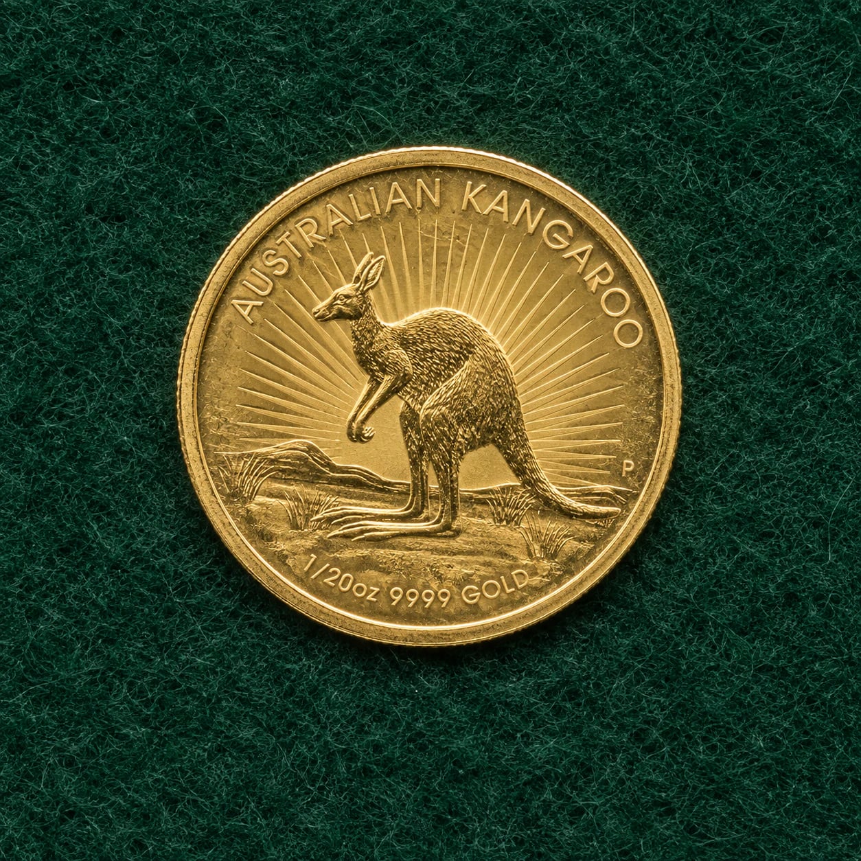 A complete older twentieth-ounce Australian Gold Kangaroo coin with light wear on green felt