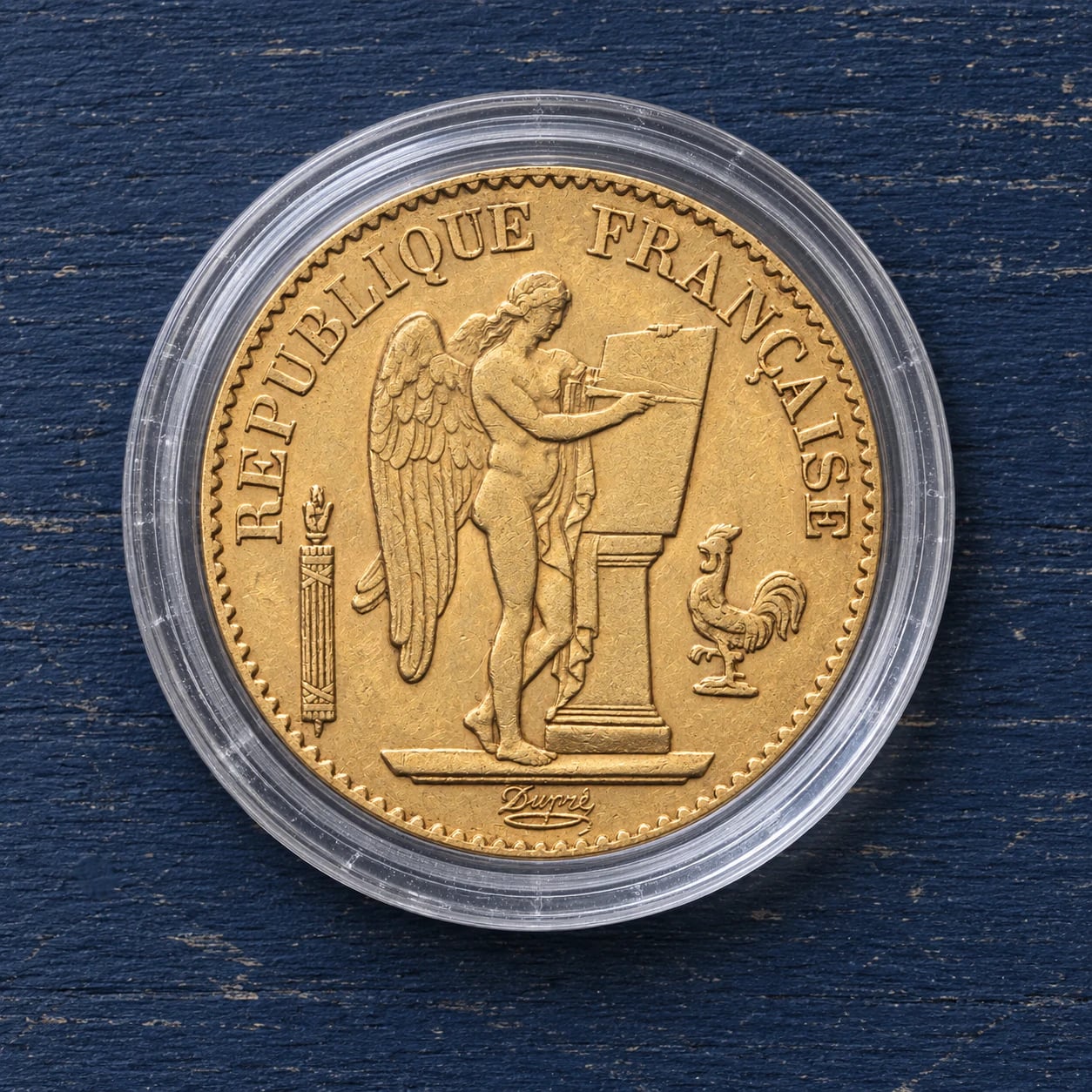 A complete 1877 French 20 Franc Génie gold coin in a clear capsule