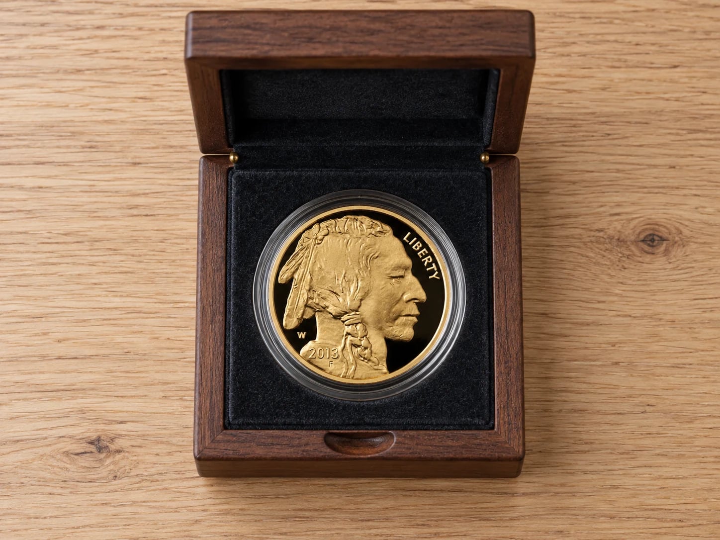 A complete American Gold Buffalo proof coin showing the Native American portrait in a presentation box