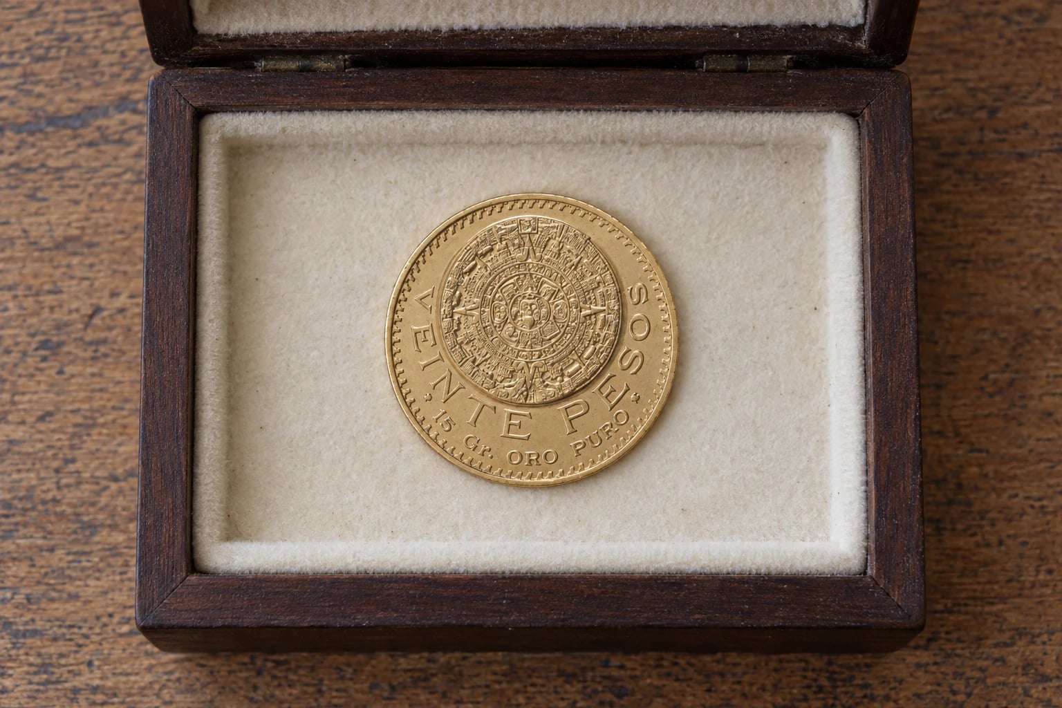 A complete Mexican 20 Pesos Azteca gold coin stored in a simple home keepsake box