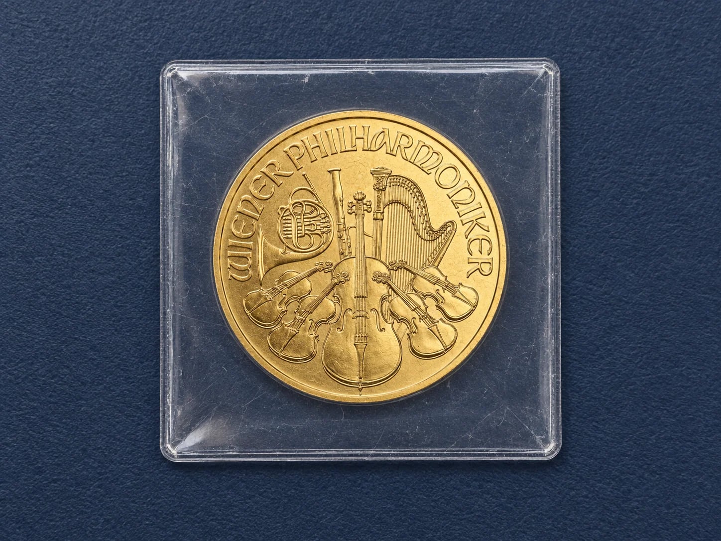 A complete Austrian Gold Philharmonic coin stored in a clear plastic flip