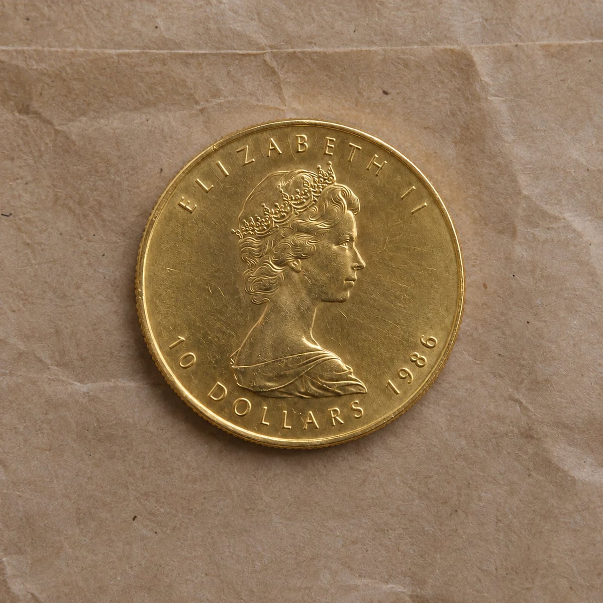 A complete 1986 quarter-ounce Canadian Gold Maple Leaf coin showing Queen Elizabeth II