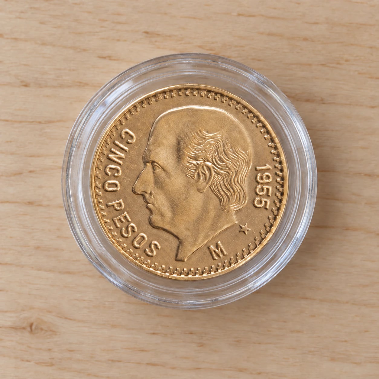 A complete 1955 Mexican 5 Pesos Hidalgo gold coin in a clear round capsule