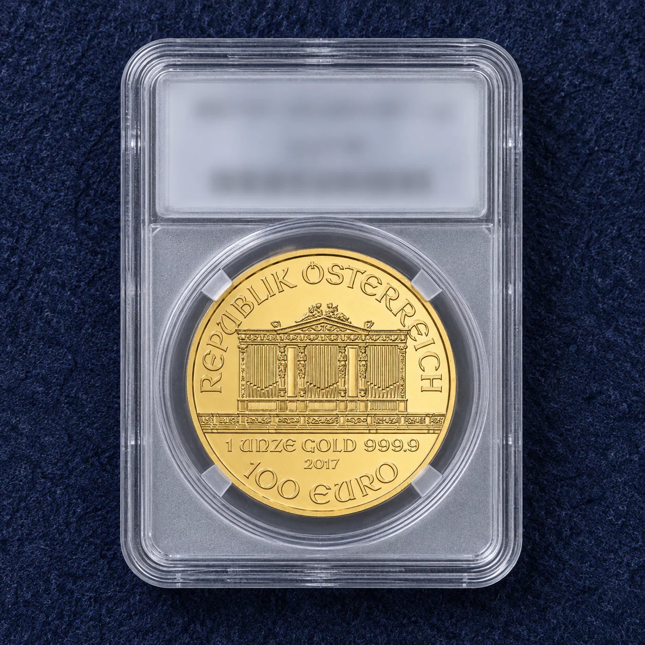 A complete high-grade one-ounce Austrian Gold Philharmonic organ-face coin in a professional holder