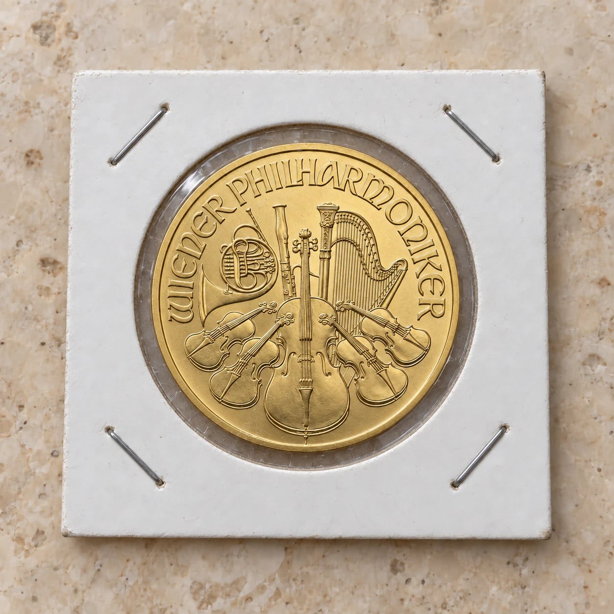 A complete satin-finish half-ounce Austrian Gold Philharmonic coin in a cardboard holder