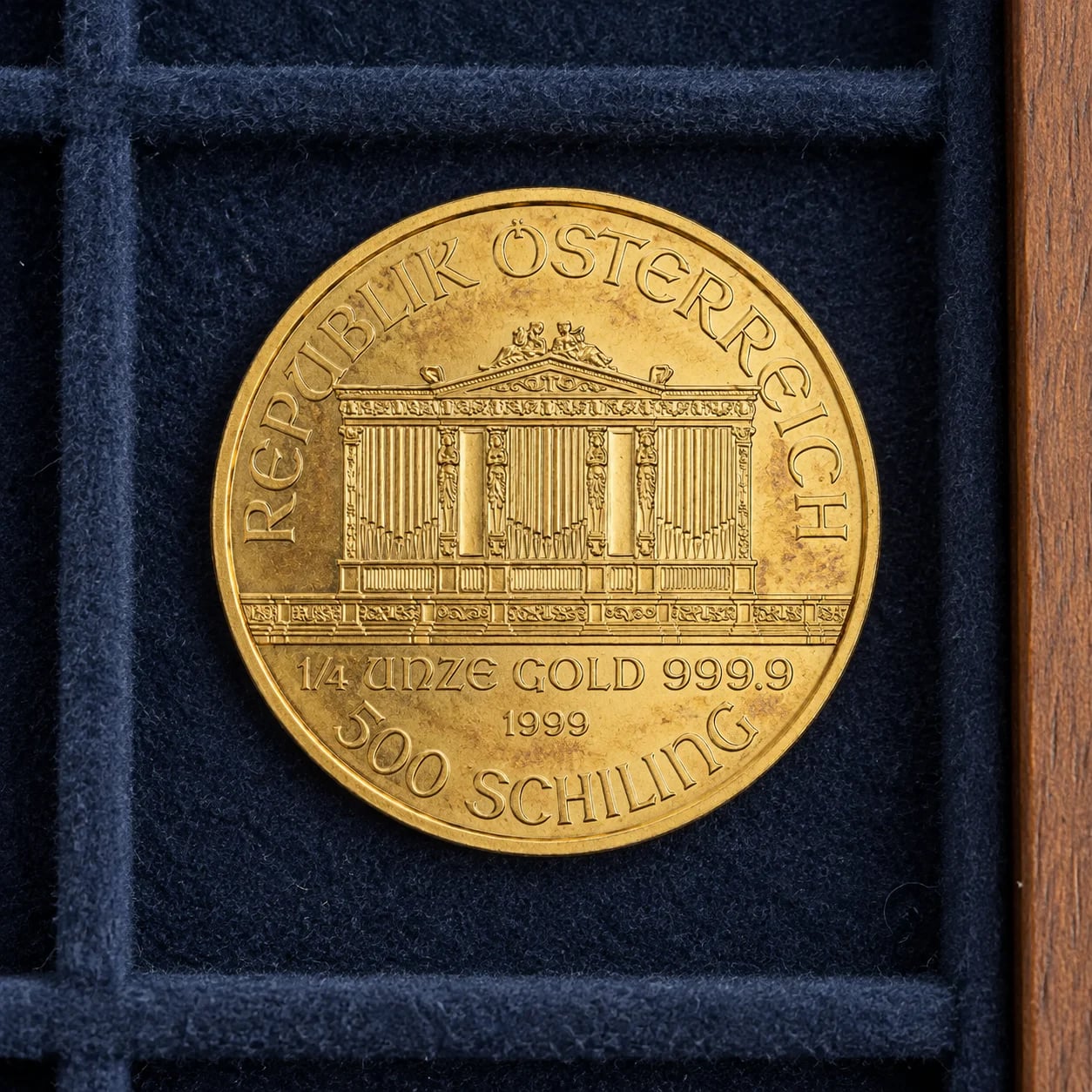 A complete toned 1999 quarter-ounce Austrian Gold Philharmonic coin in a felt-lined drawer