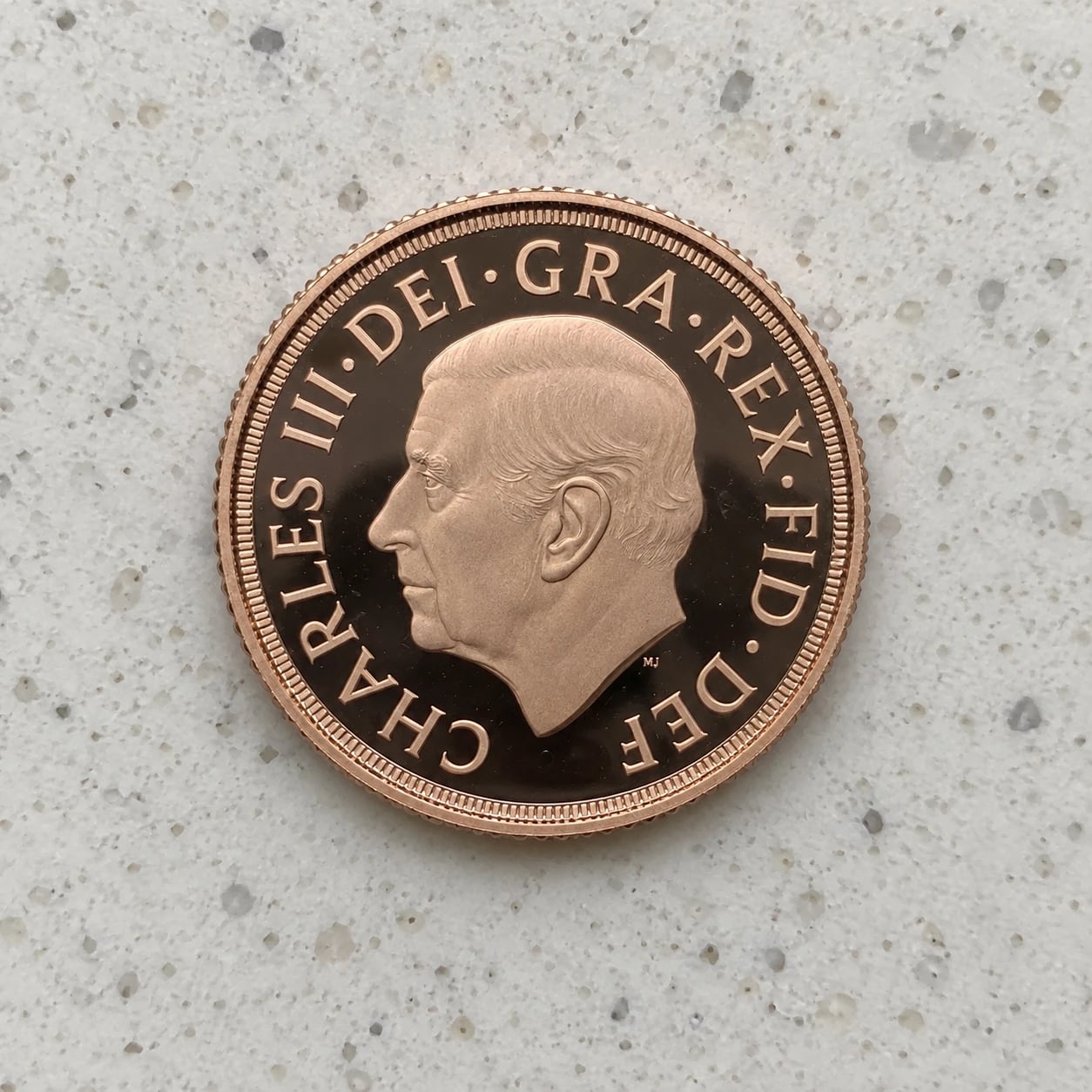 The Charles III portrait side of a proof Gold Sovereign coin