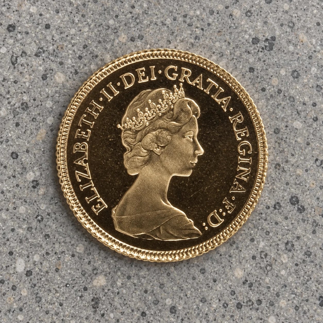 The Elizabeth II portrait side of a gold Half Sovereign coin
