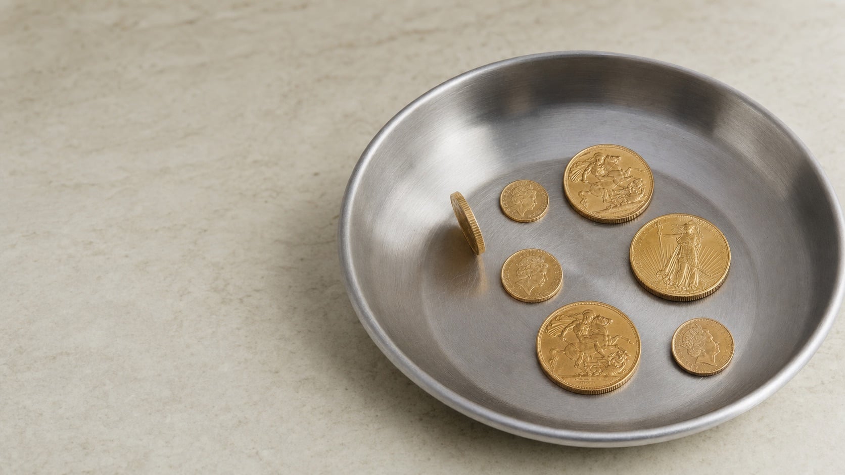 A Bullion House specialist inspecting a gold coin during a valuation